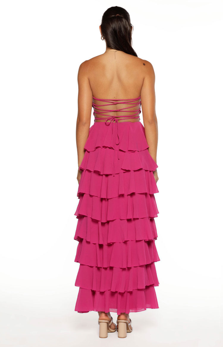 Rear view of the fuchsia strapless maxi dress with a criss-cross lace-up back and full tiered ruffle skirt