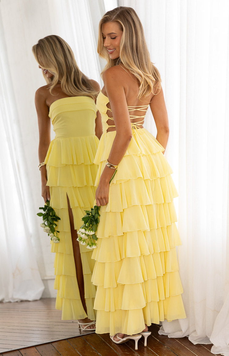 Back view of a yellow tiered ruffle gown with a lace up back detail perfect for Prom