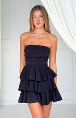 Black strapless mini dress with horizontal pleats on the bodice and a three-tiered ruffle skirt