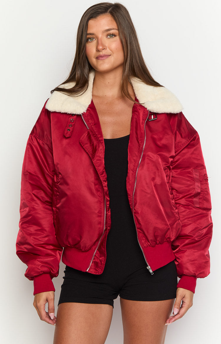 Mulberry red puffer jacket with a cream faux fur collar and silver zipper, worn open