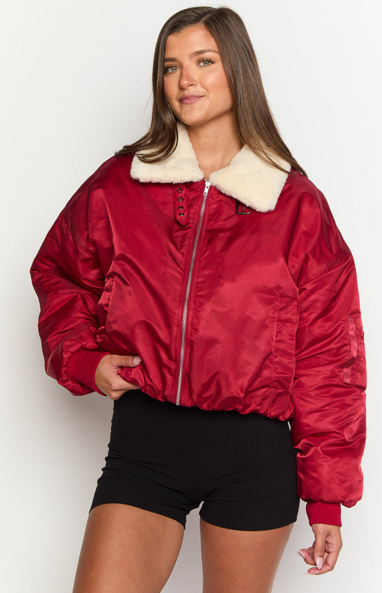 Front view of a mulberry red puffer jacket with a cream faux fur collar, silver zipper, and ribbed cuffs