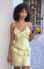 Yellow satin mini dress with a V-neckline and tiered ruffles across the bodice and skirt