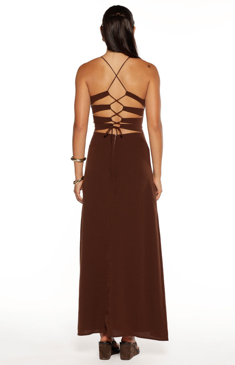 Brown maxi dress from the back showing criss-cross straps, horizontal cutouts, and lace-up closure