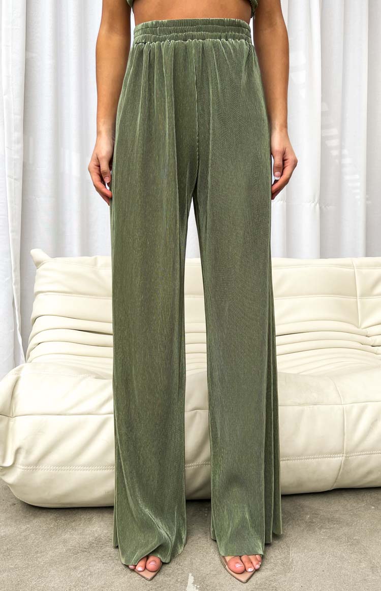 Full length view of the khaki pleated wide-leg pants with a visible elasticated waist