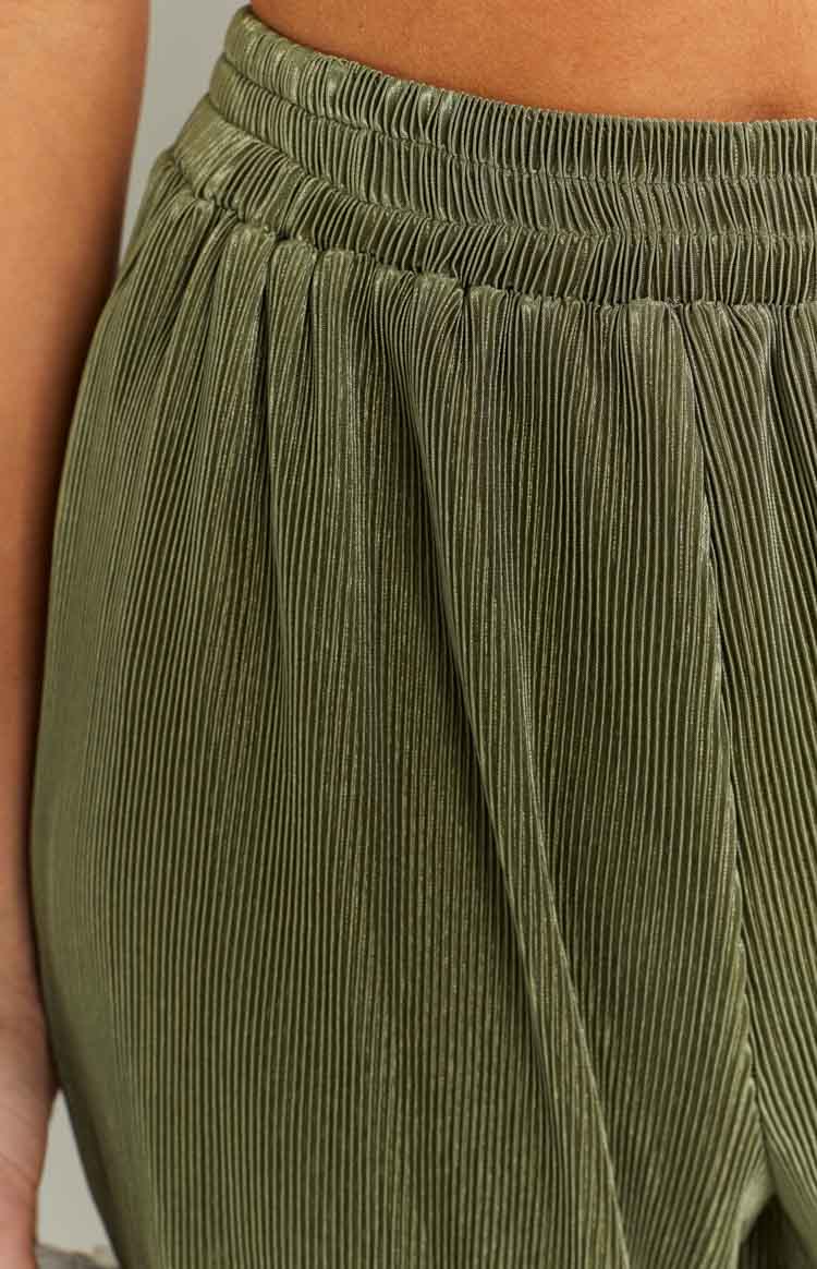 Close-up of the elasticated shirred waistband and textured plissé fabric of the khaki pants