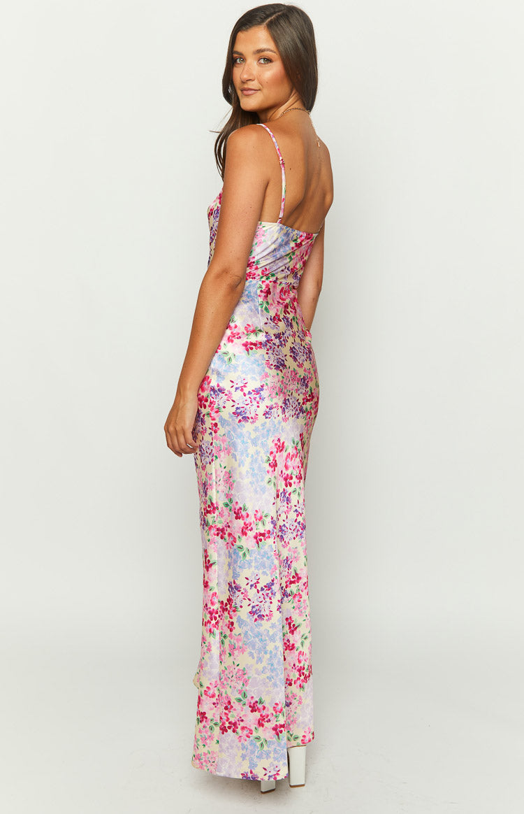 Front view of a fitted maxi dress with a pink, purple, and blue floral print and cowl neck