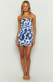 Front view of a blue and white abstract swirl print strapless mini dress with a high side slit