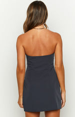 Rear view of a navy strapless mini dress with a fitted bodice and vertical seams