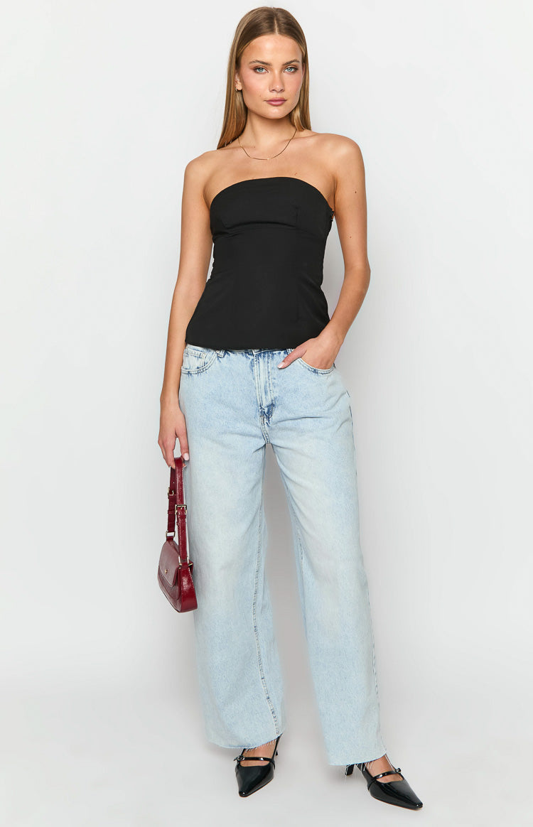 Black strapless top with a straight neckline, fitted bodice, and a subtle peplum hem