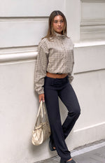 Front view of a beige plaid funnel neck jacket with a relaxed fit, cropped length, and elasticated hem
