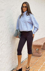 Front view of a light blue pinstripe funnel neck jacket with a silver zipper and elasticated cropped hem