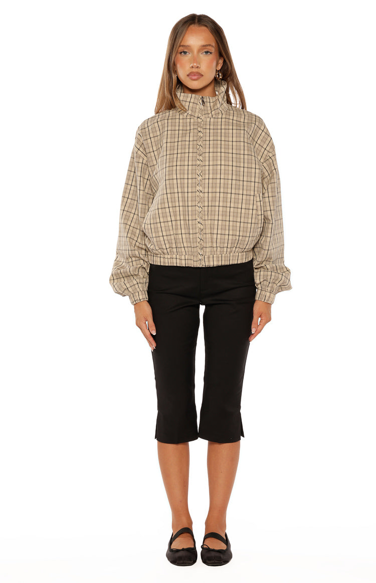 Rear-side view of the beige plaid funnel neck jacket, featuring a high collar and relaxed voluminous sleeves