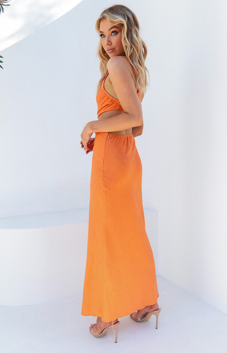 Side view of an orange maxi dress with a gathered crop-style top and waist cut-outs
