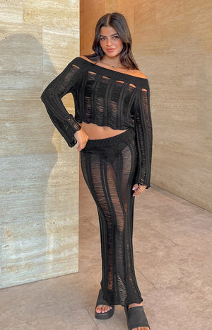Black ladder knit midi skirt with a ribbed waistband and vertical sheer stripes