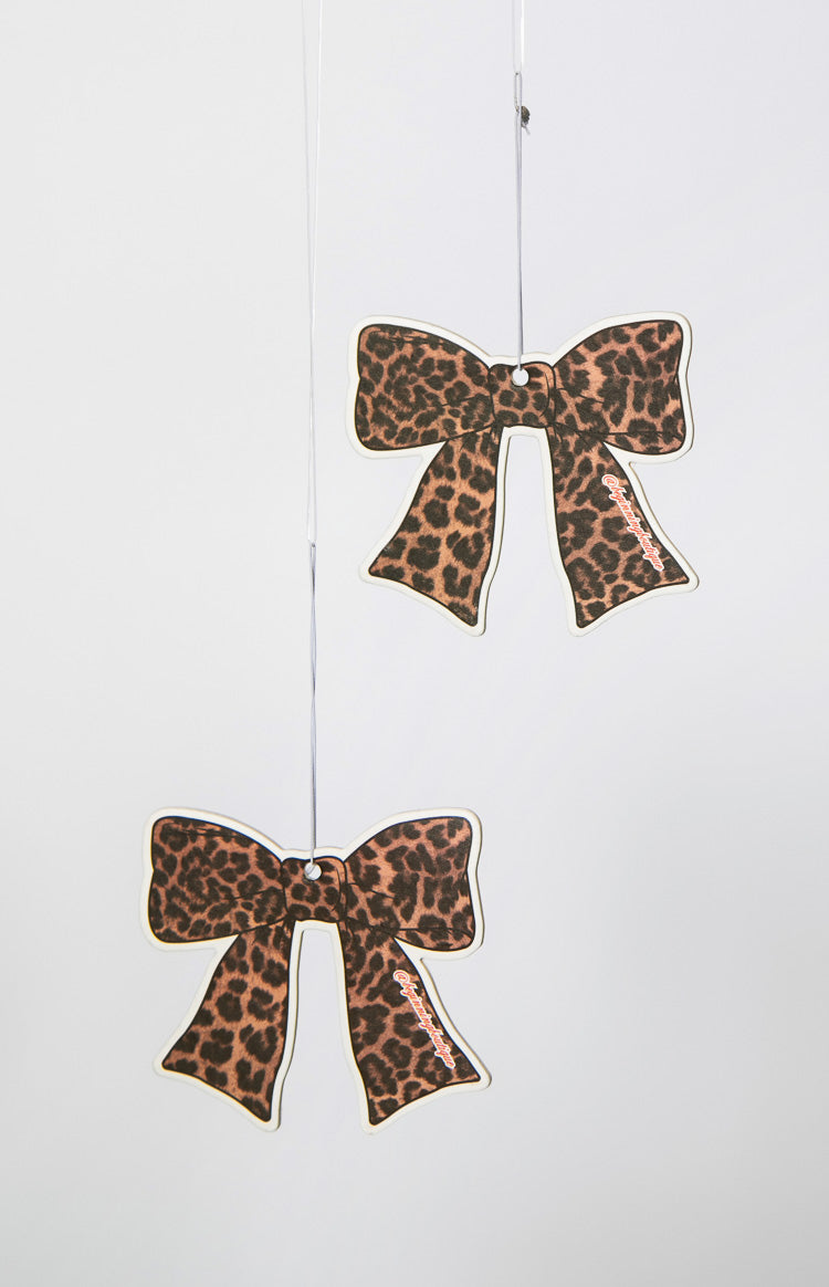 Two leopard print bow-shaped air fresheners hanging with white strings