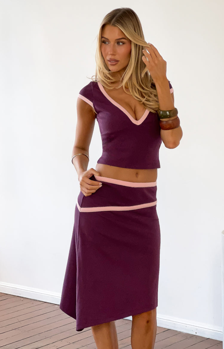 Grape jersey crop top with deep V-neckline and short cap sleeves, both featuring light pink contrast binding