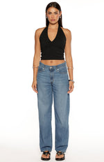Front view of mid wash baggy dad jeans with a relaxed straight leg and classic five-pocket styling