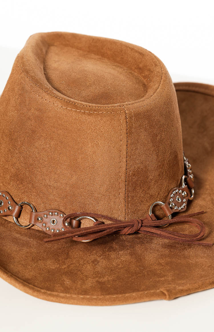 Detail shot of the tan suedette western hat, showing the studded PU trim band with silver rings and a tied leather cord