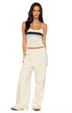 Front view of white wide-leg pants with light blue side stripes and elasticated waist