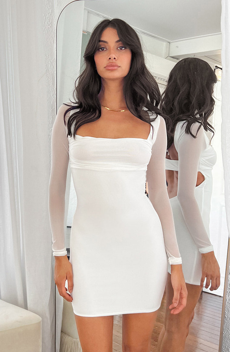 White bodycon mini dress with sheer mesh long sleeves, square neckline, and ruched bust
