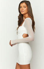 Side view of a white mesh long sleeve dress with ruched bust, side cutout, and thumbhole detail