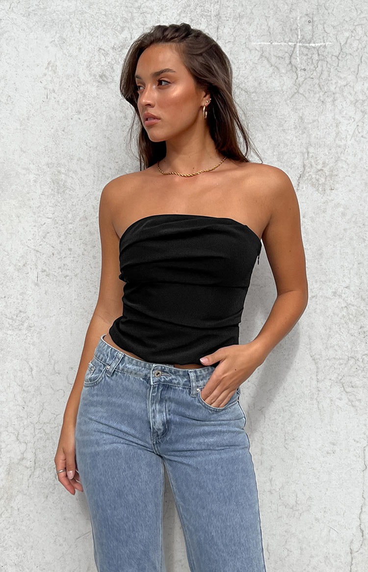 Close-up of the black strapless top showing the gathered bust detail, horizontal paneling, and side zipper