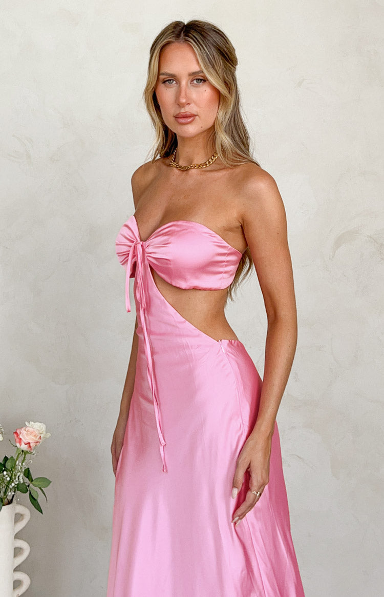 Rear-side view of a pink satin strapless maxi dress showing the ruched elastic back band and open back detail