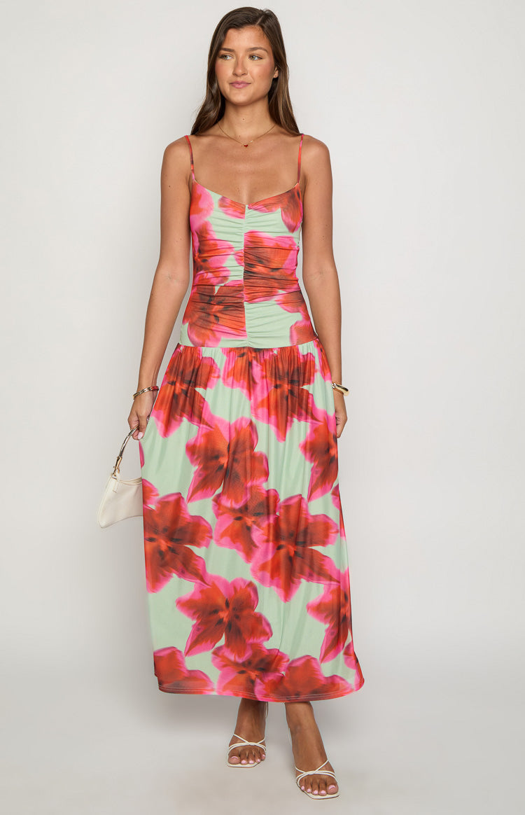Front view of a light green maxi dress with large red and pink floral print and a ruched sweetheart neckline