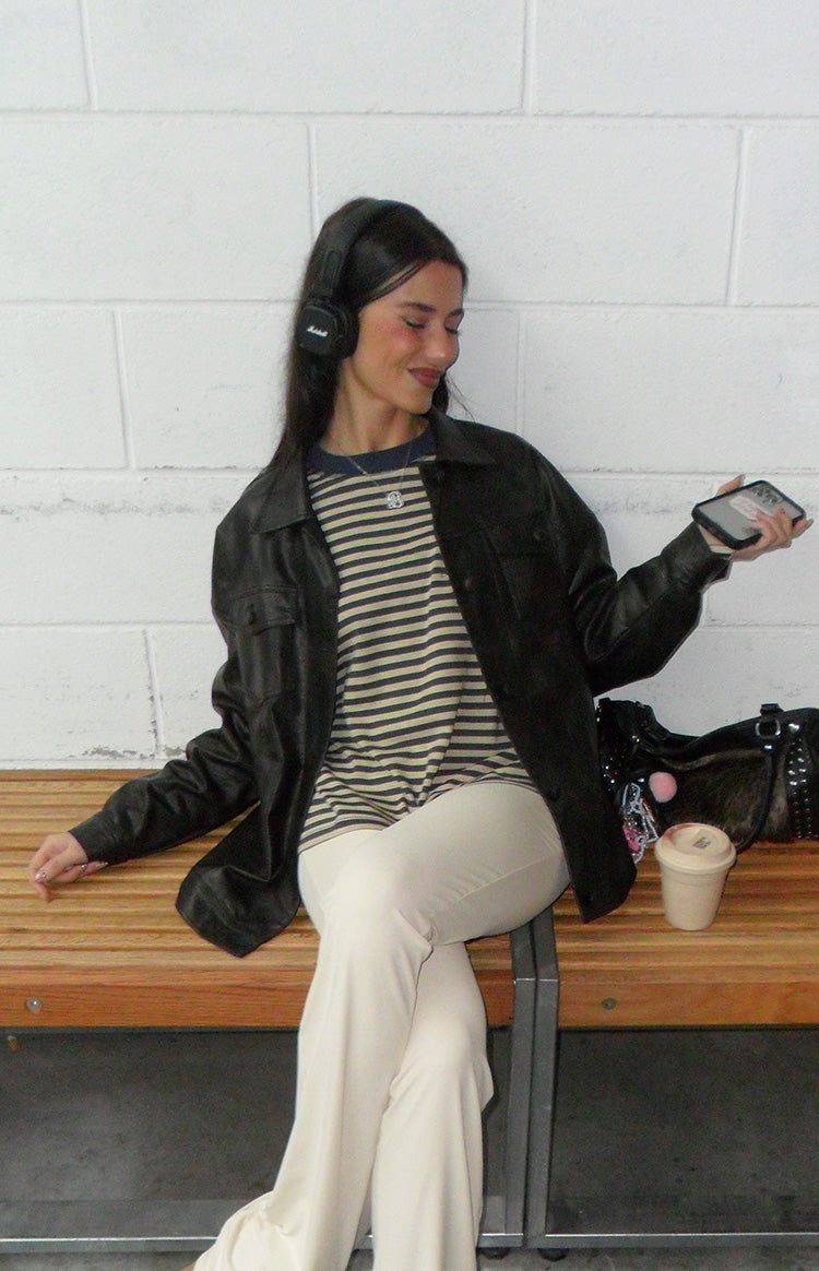 Close-up of the beige and navy striped long sleeve top with a navy crew neck