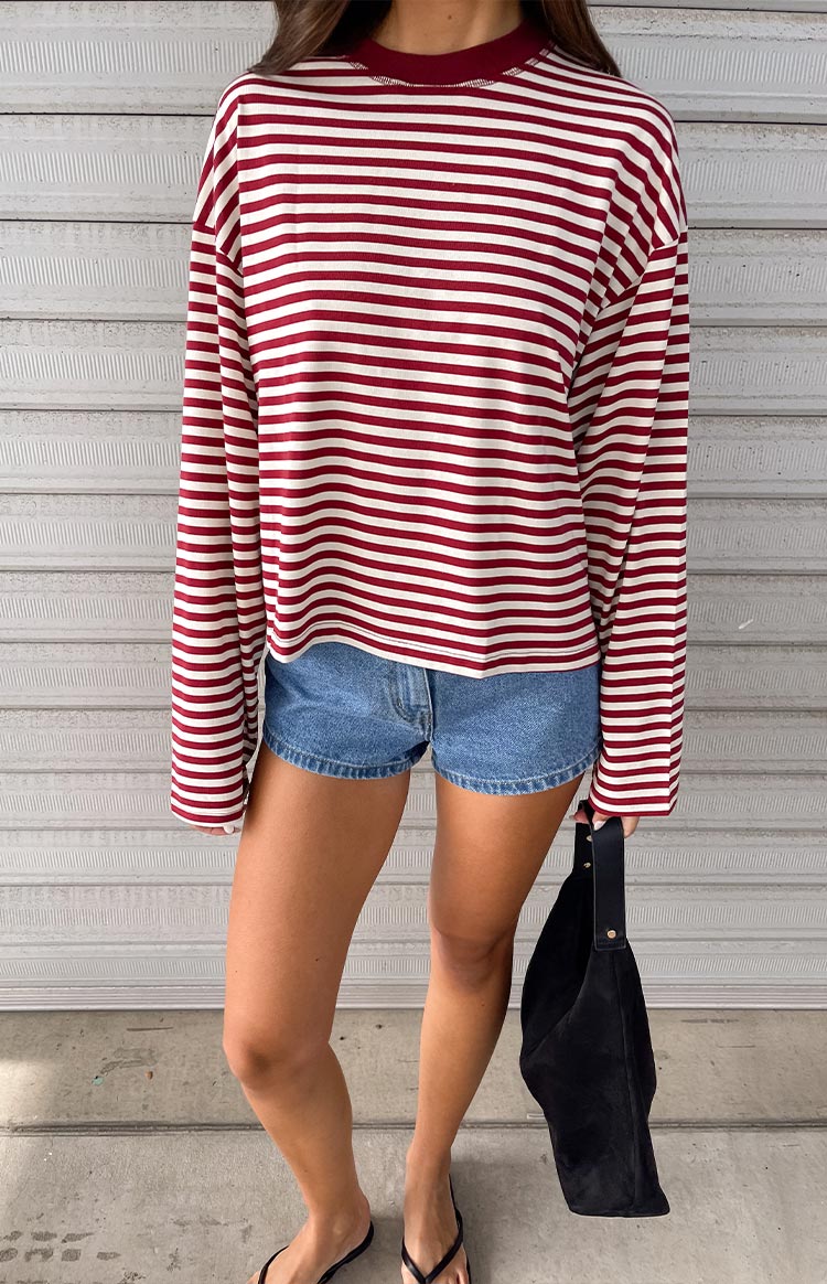 Front view of a wine red and white striped long sleeve top with a mock neck and relaxed fit