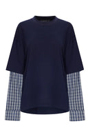 Beginning Boutique Lioness Bottega Navy Layered Contrast Sleeve Shirt — navy oversized crew neck shirt with blue plaid long sleeves and an asymmetrical cropped hem