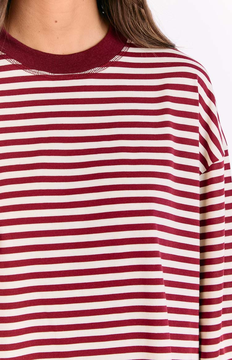 Close-up of the ribbed crew neckline and horizontal wine red and off-white stripes