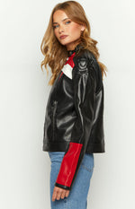Side view of a black biker jacket with red and white stripe details, a zippered pocket, and red lower sleeve panels