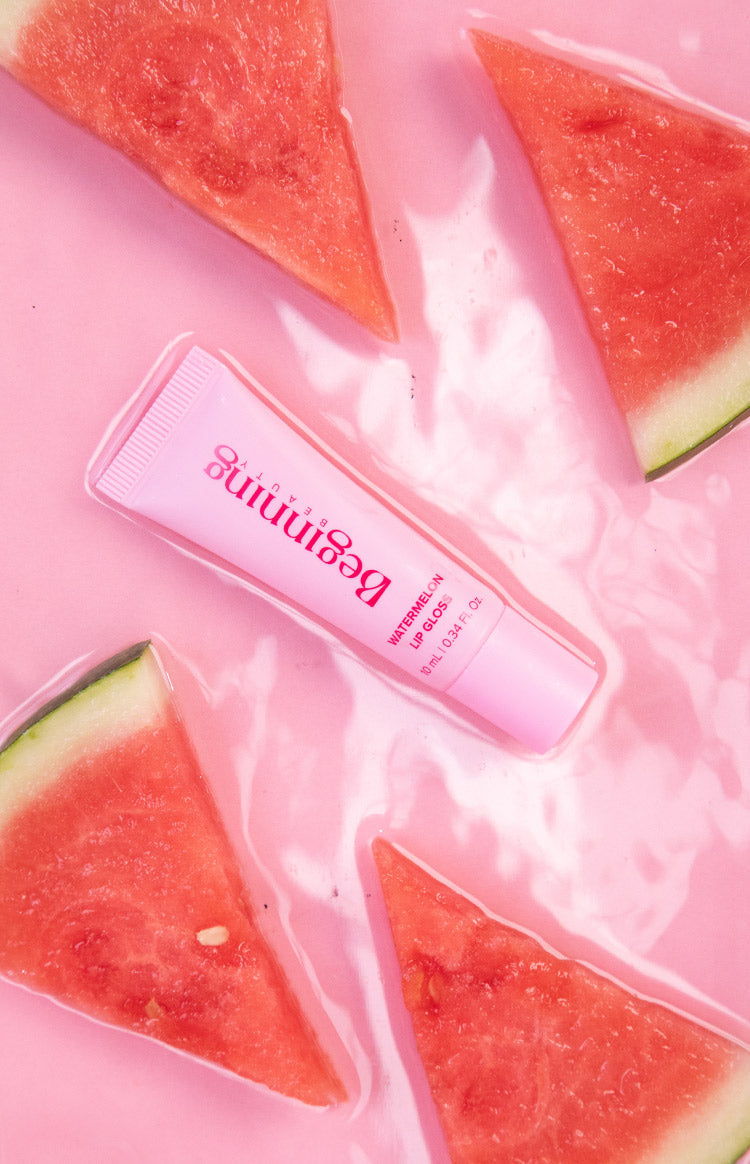 Light pink soft plastic squeeze tube of lip gloss with a ribbed screw-top cap