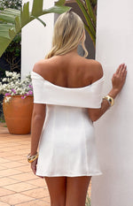 Rear view of a white off-shoulder mini dress with a folded neckline and A-line skirt with vertical seams