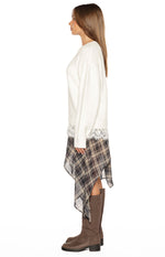 Side view of the cream fluffy knit sweater showing the relaxed fit and white lace trim at the hem