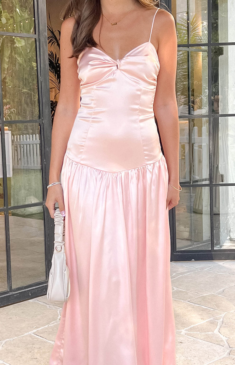 Close-up of the pink satin maxi dress bodice with a twisted knot detail and ruched side panel