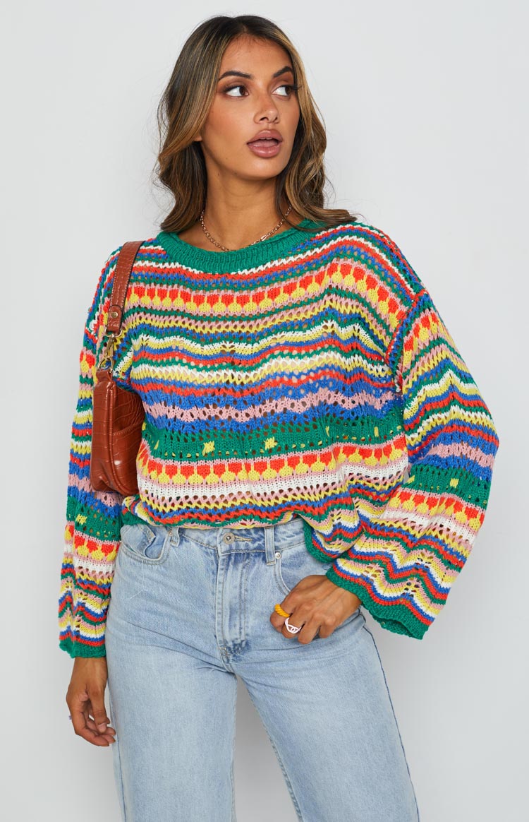 Multi-coloured striped open knit sweater with a green ribbed crew neck and long balloon sleeves