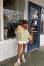 White knit ruffle shorts with tiered lace trim and a short length