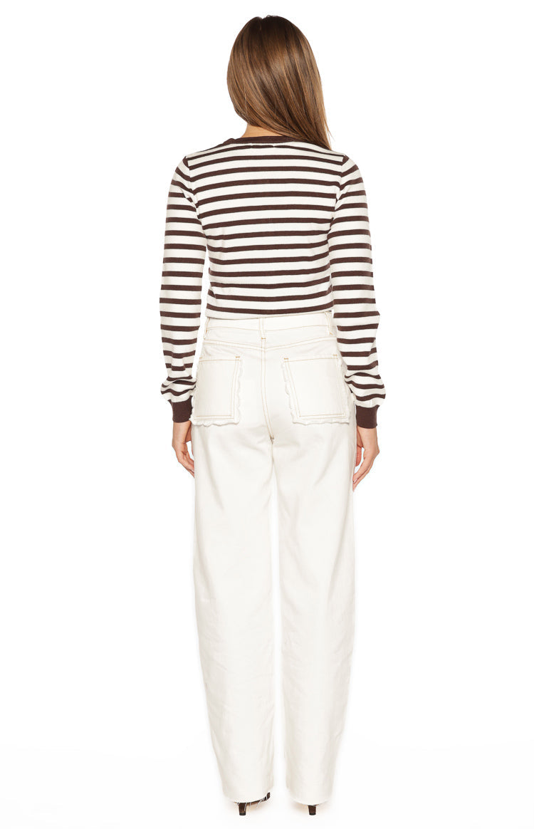 Rear view of a chocolate and white striped long sleeve cardigan with ribbed cuffs
