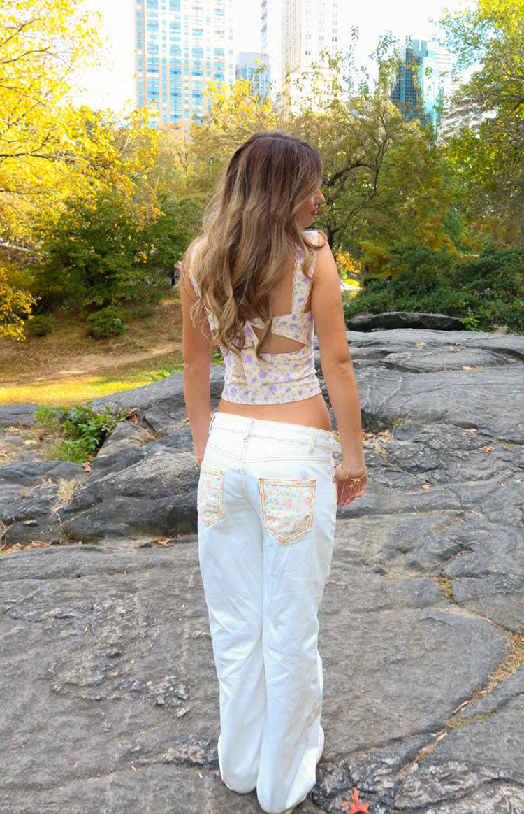 Rear view of a purple floral corset top with a cut-out back and lace-trimmed straps