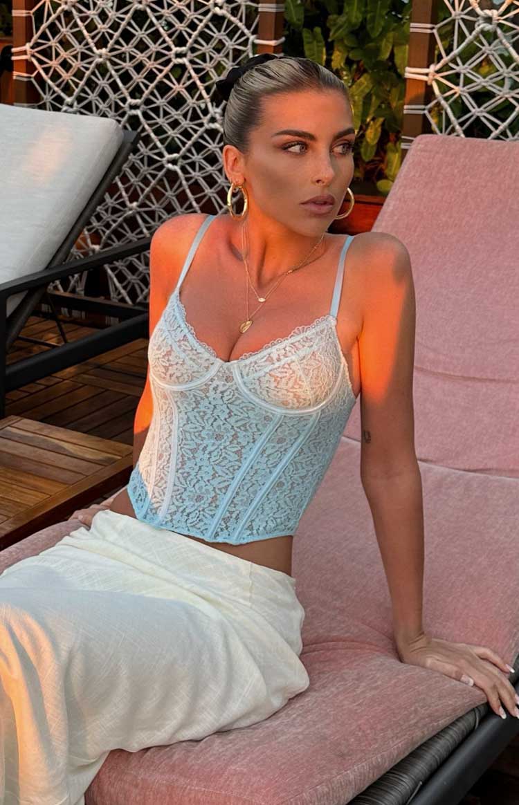 Light blue lace corset top with sweetheart neckline, thin straps, and structured boning detail
