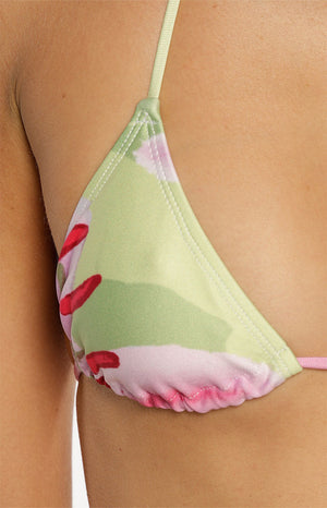 Close-up of our triangle bikini top featuring an abstract floral print in lime green pink and white. This top has thin string ties.