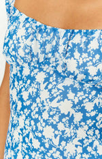 Close-up of the ruched square neckline and blue and white floral pattern on the mini dress