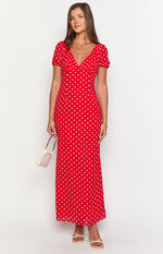 Red polka dot maxi dress with a V-neckline, short puff sleeves, and a flowing skirt