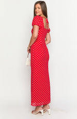 Side view of a red polka dot maxi dress with short puff sleeves and a square back neckline with ties