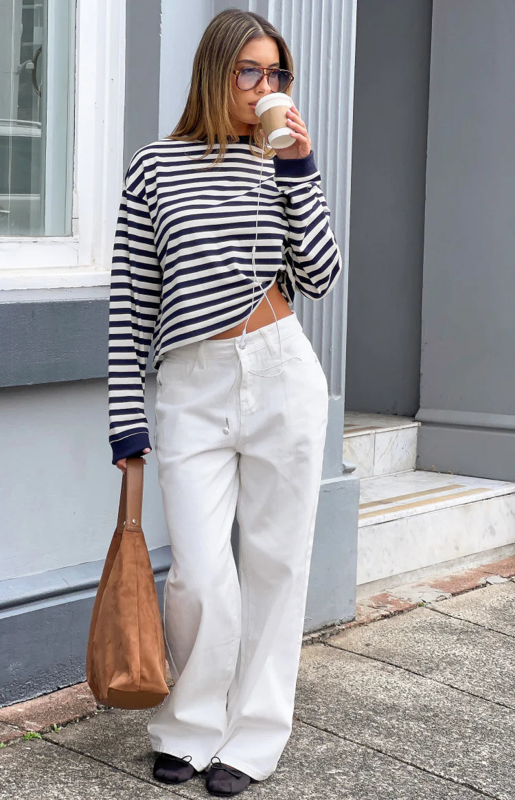Full length view of white denim slouchy jeans with a relaxed wide leg and drawstring waist