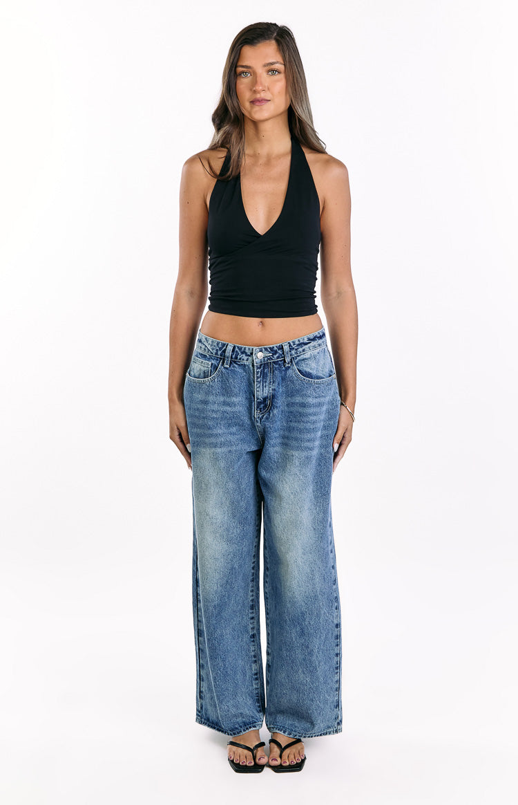 Front view of mid wash denim slouchy jeans with a relaxed wide leg fit