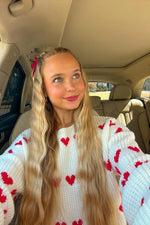 Crew neck white chunky knit jumper with red heart pattern on chest and sleeves