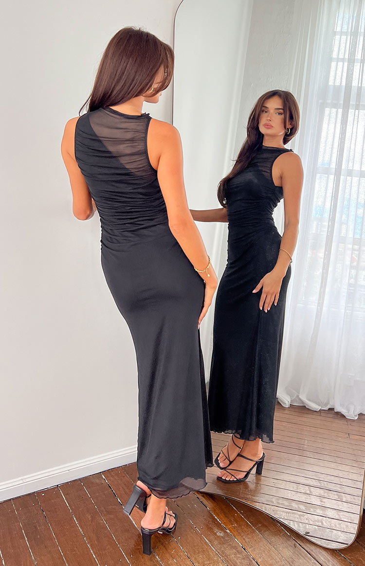 Rear view of a black maxi dress with a sheer ruched mesh upper bodice and lettuce hem